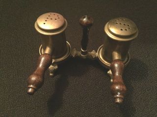 Vintage brass salt and pepper shakers with wooden handles brass on brass stand 2