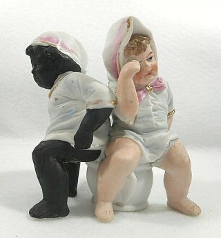 Bisque Figure Of A Black And White Boy Sharing The Same Chamber Pot