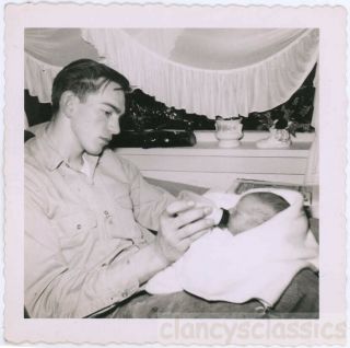 1960s Young Father Feeding Baby Bottle Of Milk Snapshot