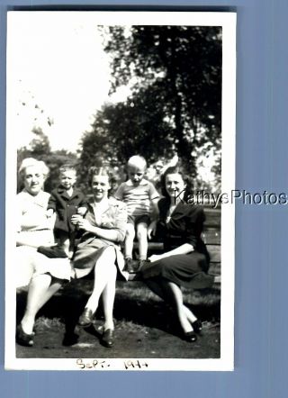 Black & White Photo B,  1528 Women In Dresses Sitting On Bench With Boys