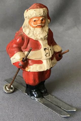 Vintage 2 - 3/4” Cast Metal Santa On Skis