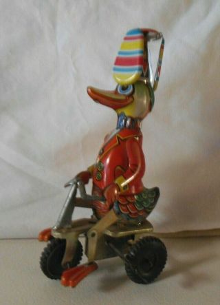 Vintage Wind Up Duck On Bike Trike China Spinning Hat Metal Toy Tin