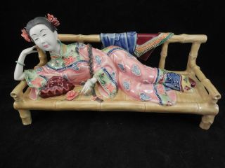 Mid 20th Century Chinese Or Japanese Pottery Figure Of A Woman On Bamboo Bench