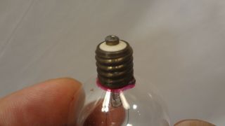 antique light bulb c6 miniature base machine turned early base.  Edison? Rare 3