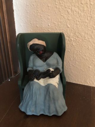 African American Woman Holding A Toddler Figurine