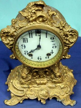 N - 367.  Gilbert 30 Hour Time & Strike Brass Ornate Decorated Mantle Clock,  Porc