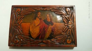 Wooden Icon With A Carved Pattern And A Picture Of Jesus Christ With A Disciple