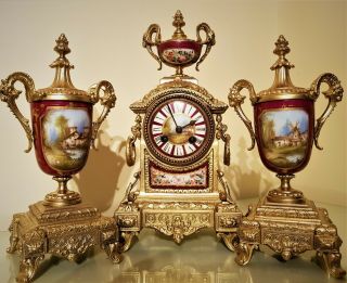 19th Century French Gilt And Porcelain Clock Garniture.