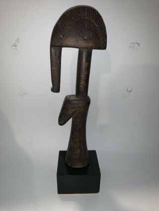 A Shapely And Abstract Carved Wood Female Doll,  Burkina Faso