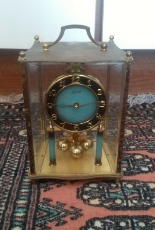 A Vintage Glass Cased Kundo Anniversary Clock