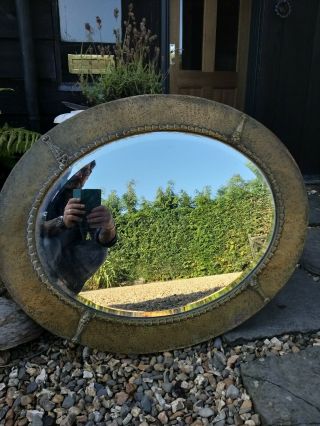 A Large Arts And Crafts Brass Repousse Wall Mirror