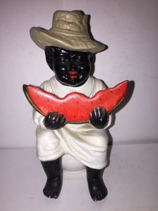 Bisque Figure Of A Black Boy Sitting On A Chamber Pot Eating A Slice Watermellon