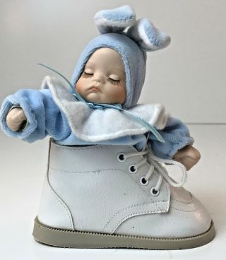 Cute Bisque Baby Doll Dressed In Blue Bunny Suit Sitting In Baby Shoe Music Box