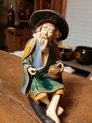 Vintage Oriental Chinese Mud Man Figurine.  Sitting With Basket.  Tall,  Older.