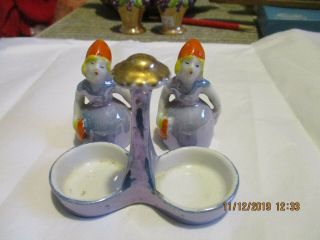 Vtg salt and pepper shakers set Japan luster two ladies in holder.  good cond, 2