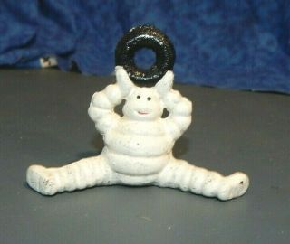 Michelin Tire Man Figure Sitting Holding Tire Above Head Cast Iron Paperweight