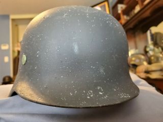 M 35 German helmet with liner and buckle end of chinstrap. 2