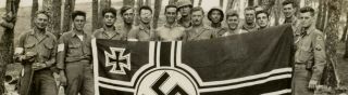 photo of GI ' s with invasion armbands holding a captured flag 2