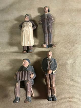 A Vintage Set Of Four Wood Carved Figurines