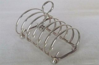 A Stunning Boxed Solid Sterling Silver 7 Bar 6 Slice Toast Rack Sheffield 1990.