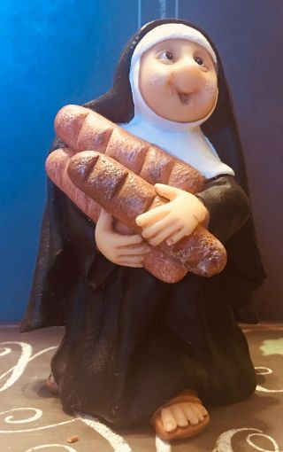 Polymer Clay Figurine: A Nun Carrying Her Loaves Of French Bread.