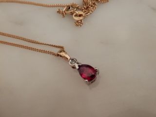 A Stunning 9 Ct Gold Oval Ruby And Diamond Pendant And Chain