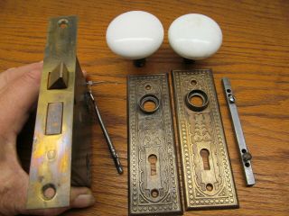 Old Lockset.  Stamped Metal Door Plates.  White Knobs.  Ornate