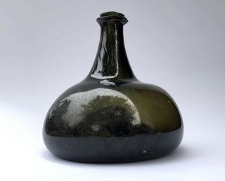 English Black Glass Onion Bottle,  Queen Anne / George I,  1710