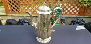 An Antique Victorian Silver Plated Tea Pot With Floral Respoused Patterns.