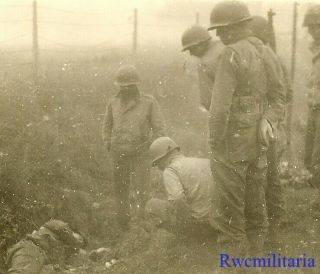 Somber Us Troops Looking Over The Body Of Kia German Soldier; France 1944