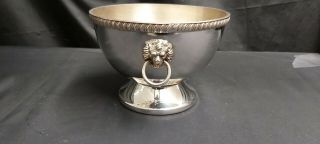 An Antique Silver Plated Bowl With Embossed Lions Heads And Beading Patterns.