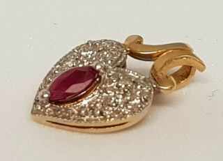 A Stunning 9 Ct Gold Oval Ruby And Diamond Pendant