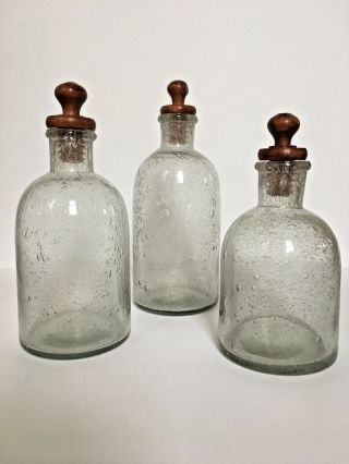 Set Of 3 Decorative Grayish Green Blown Glass Bottles With Wood Stoppers