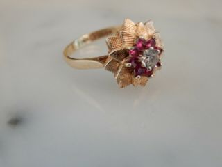 A 9 Ct Gold Ruby And White Topaz Foliate Ring