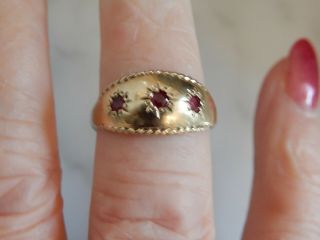 A 9 Ct Gold Decorative Ruby Three Stone Ring