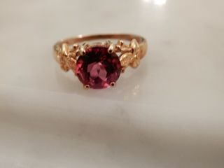 An Exceptional 9 Ct Gold Circular Pink Gemstone Ring