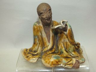 A Chinese Porcelain Figure Of A Man Reading A Book 20thc