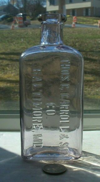 Purple Flask Embossed,  Thos G Carroll & Son Co Baltimore.  Md