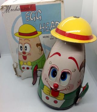 Japan Tin Mechanical Wind Up Egg Head Moving Eyes And Tang Echo
