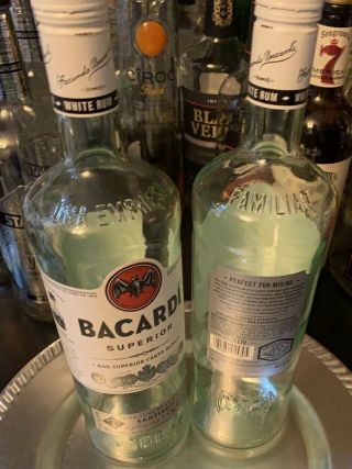 Two (2) Empty Bacardi Bottles W/lids