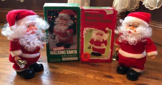 2 Vintage Musical Walking Santa Claus Toy Ringing Bell 1970 