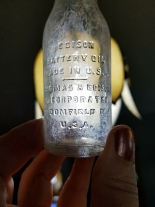 Small Vintage Clear Glass Bottle Advertising Thomas Edison Poison Battery Oil