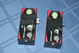 2 Vintage Tin Litho Mechanical Wind Up Yone Coffin Bank Mysterious