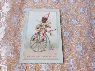 Victorian Christmas Card/black Figure Riding Penny Farthing Whilst Playing Banjo
