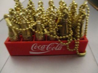 24 Mini Gold Coca - Cola Bottle Key Chains.  2 Inches In Case Nos