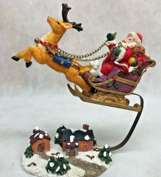 Santa On A Sleigh Pulled By A Reindeer Flying Over Village By Metal Adaptor