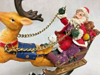 Santa on a sleigh pulled by a reindeer flying over village by metal adaptor 2