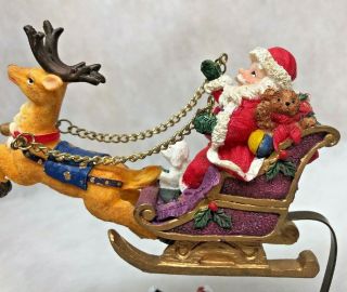 Santa on a sleigh pulled by a reindeer flying over village by metal adaptor 3