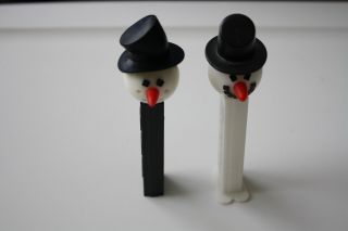 2 Pez Dispensers - Snowman,  Black No Feet,  White With Feet
