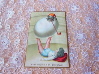 Victorian Christmas Card/boy Balancing Egg With Black Figure Inside On His Feet